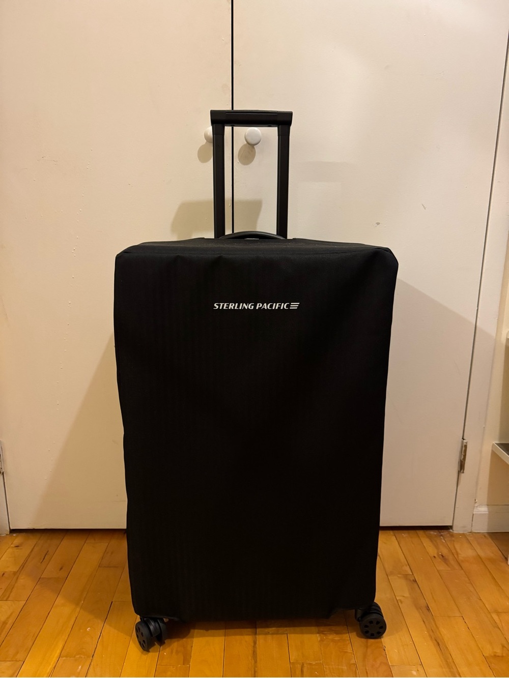 Sterling Pacific 90 liter polycarbonate black suitcase with luggage cover